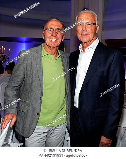 Soccer legend Franz Beckenbauer (r) and his brother Walther enjoying the gala that is being held as part of the 29th Kaiser Cup golf tournament