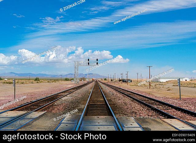 Railroad crossing gates on a road in the Mojave Desert in the Southwestern United States. California