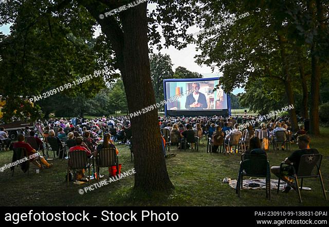 PRODUCTION - 24 August 2023, Brandenburg, Oranienburg: Numerous spectators watch the screening of the film ""Monsieur Claude and his great feast"" in the...
