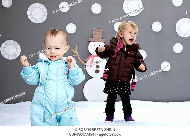 Baby girls with snow and snowman cutouts