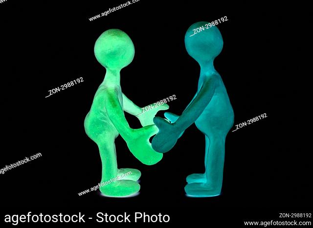 Two shaded plasticine puppets standing opposite each other