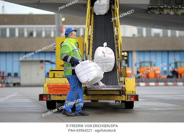 A worker loads aid packages for the victims of typhoon 'Haiyan' in the Philippines are ready to be loaded into an aircraft at Frankfurt International Airport in...