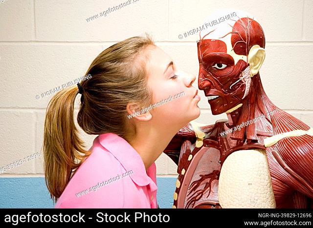 Female student kissing an anatomical model
