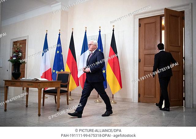10 November 2019, Berlin: Federal President Frank-Walter Steinmeier walks past the table with the guest book and the flags of France
