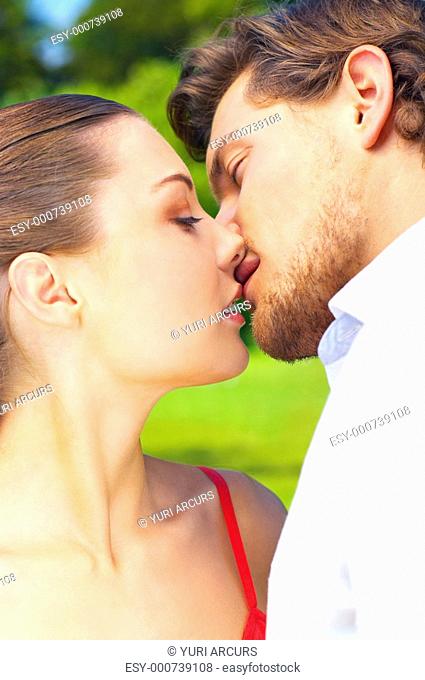 An attractive couple about to share a passionate kiss