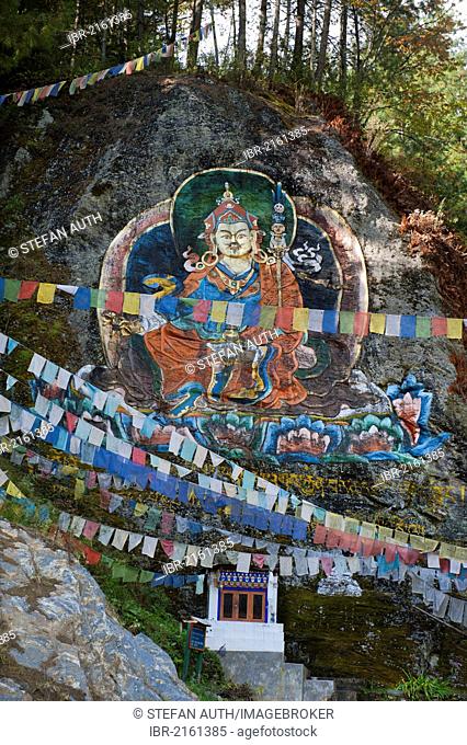 Colourful rock painting, petroglyphs, Guru Rinpoche, Padmasambhava, colourful prayer flags, near Thimphu, Kingdom of Bhutan, South Asia, Asia