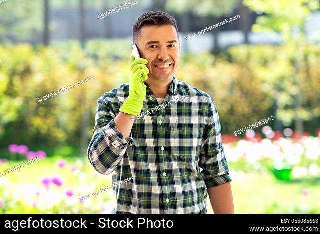 happy man calling on smartphone at summer garden