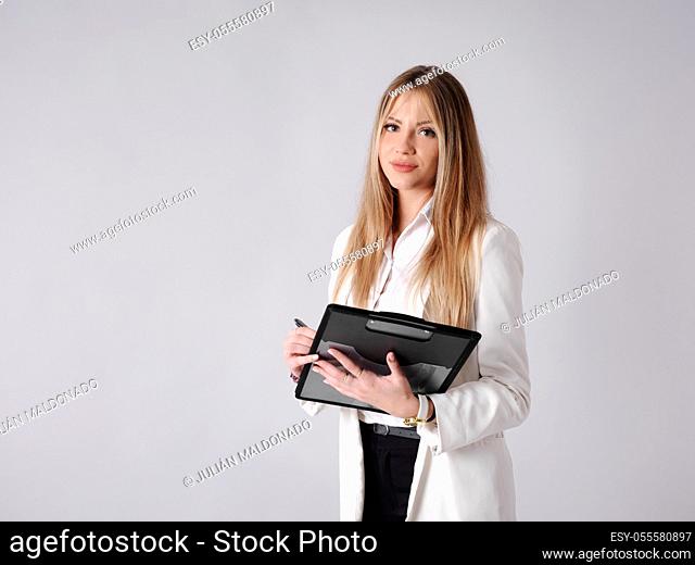 Young business woman taking notes in a folder