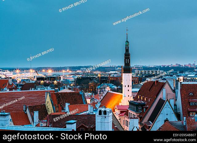 Tallinn, Estonia. Tower Of Church Of Holy Ghost Or Holy Spirit In Winter Evening Night. UNESCO Heritage Site. Night Cityscape. Destination Scenic