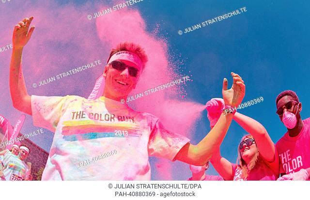 Participants in the Color Run have pink powder thrown at them in Hanover, Germany, 07 July 2013. Several thousand participants took part in a 5 km run durign...