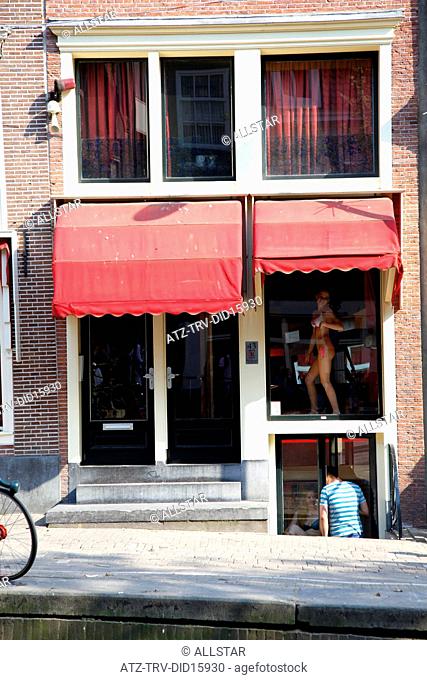 WOMAN IN WINDOW; RED LIGHT DISTRICT, AMSTERDAM, HOLLAND; 24/04/2011