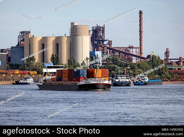 Duisburg, North Rhine-Westphalia, Germany - freighter at the southern harbor, Holcim cement plant at the back left, ThysseKrupp Steel blast furnace Schwelgern...