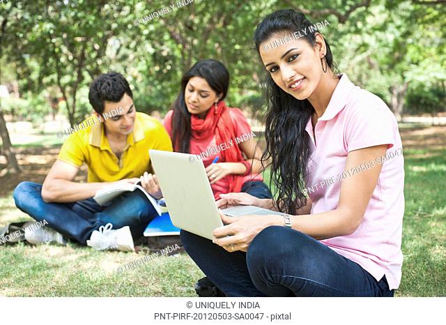 Friends studying in a park, Lodi Gardens, New Delhi, Delhi, India