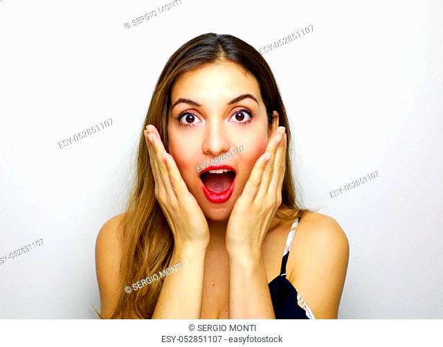 Portrait of excited young woman hands near face keeping mouth open isolated on white background. People sincere emotions lifestyle concept