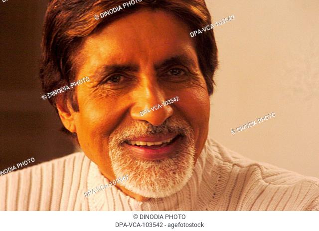 South Asian Indian Bollywood film star Amitabh Bachchan smiling shooting for ad film in Mehboob studio ; Bombay Mumbai ; Maharashtra ; India