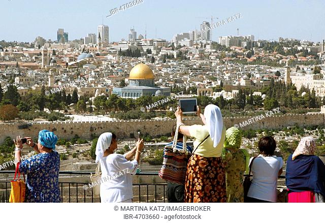 Women photograph the Dome of the Rock, qubbat as-sachra, Kipat Hasela, on the Temple Mount, Old Town, and the Skyline, Jerusalem Israel
