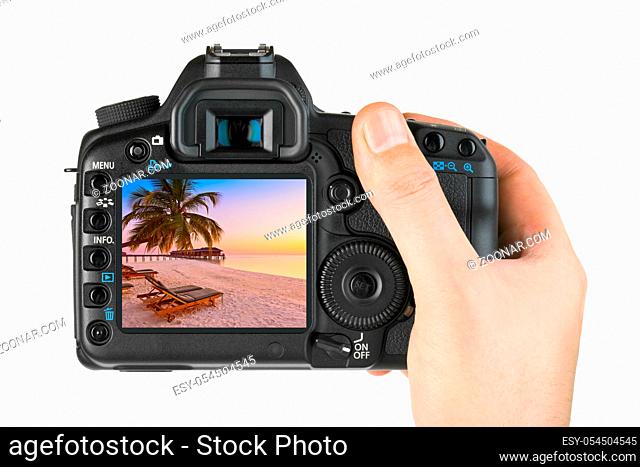 Hand with camera and Maldives beach photo (my photo) isolated on white background
