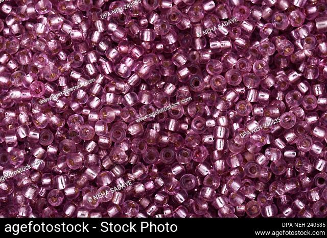 Pink shiny beads close-up on a backgroun