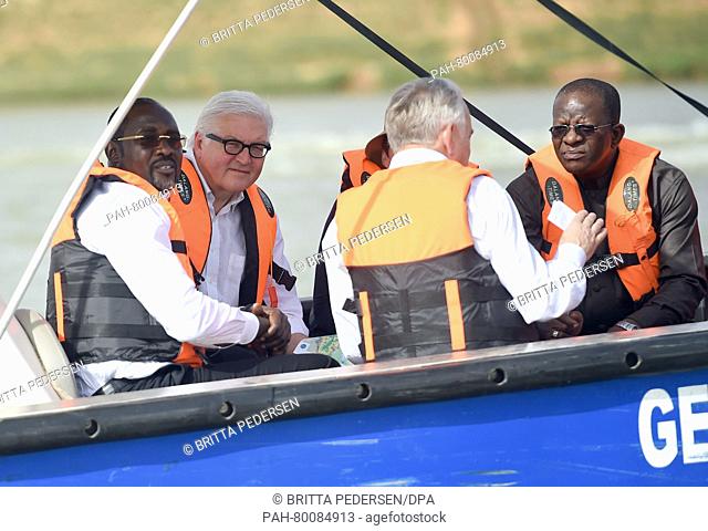 German foreign minister Frank-Walter Steinmeier (2-L) and his French counterpart Jean-Marc Ayrault (2-R) ride a boat on Niger river as they are being briefed on...