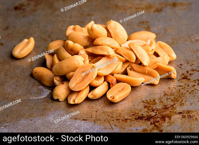 healthy natural brown peanuts on a steel plate