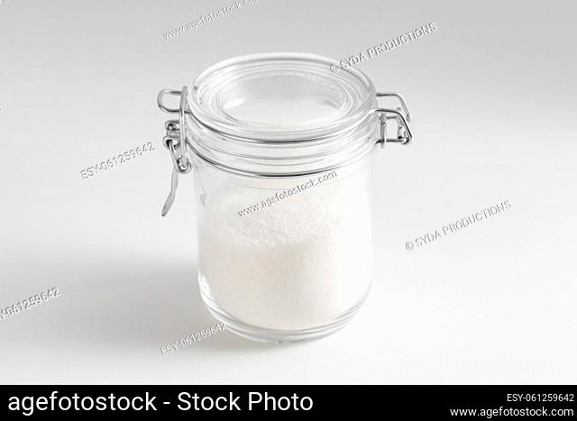 close up of white sugar glass jar on table