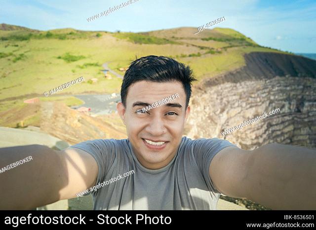 Adventurous man taking a selfie at a viewpoint. Close up of person taking an adventure selfie, Tourist taking a selfie at a viewpoint