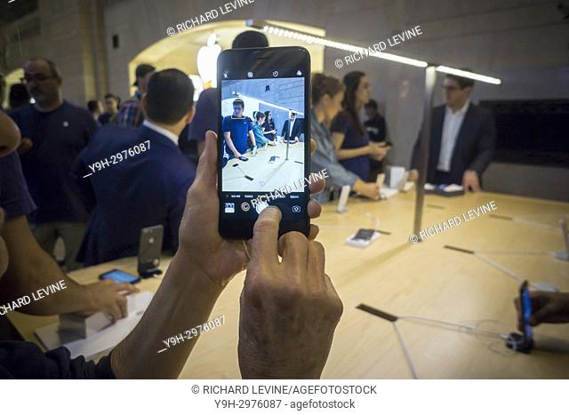 A customer in the Apple store in Grand Central Terminal in New York uses the camera in a new iPhone 8 Plus on Friday, September 22, 2017