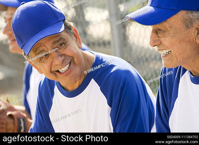 Senior Hispanic men playing on baseball team