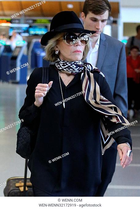 Jane Fonda shows up to Los Angeles International Airport wearing a fedora, silk scarf, and gold sandals Featuring: Jane Fonda Where: Los Angeles, California