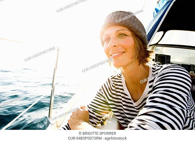 Smiling woman standing on boat