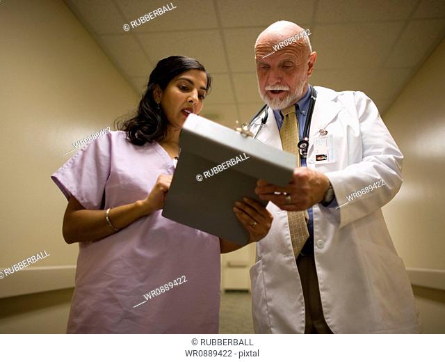 Low angle view of a male doctor talking to a female nurse