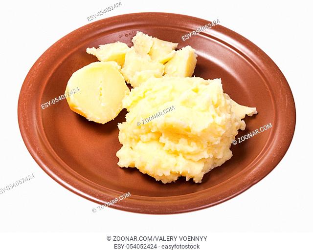 boiled and mashed potatoes on brown plate isolated on white background