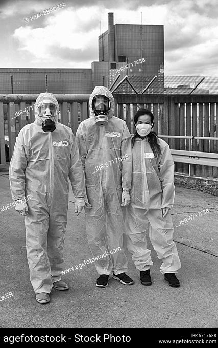 People in protective suits and wearing gas masks demonstrate in front of the former nuclear power plant Würgassen, Beverungen, county Höxter