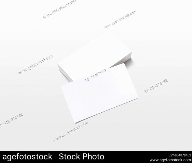 Photo of blank business cards with soft shadows on light gray background. For design presentations and portfolios. Isolated with clipping path