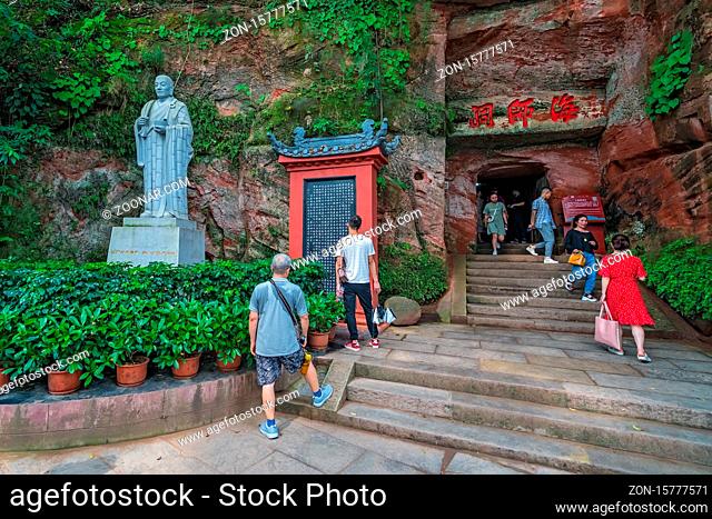 Leshan, China - July 2019 : Buddhist temple and shrine cut out in a rock on the wall of a rocky mountain above The Giant Leshan Buddha
