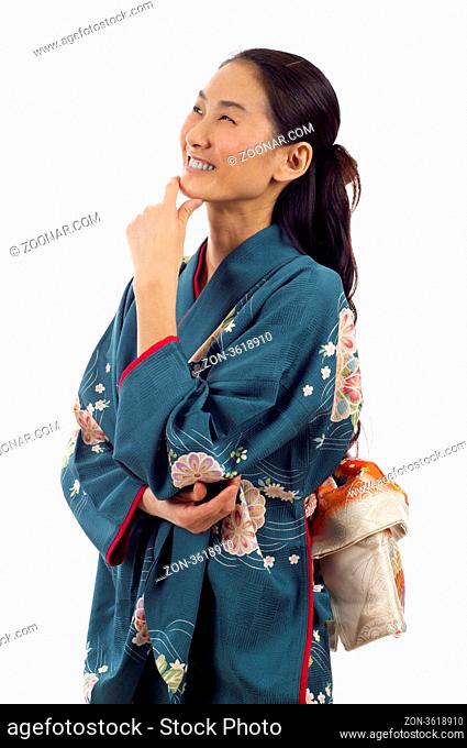 Beautiful thoughtful Japanese kimono woman looking up at copyspace isolated over white background