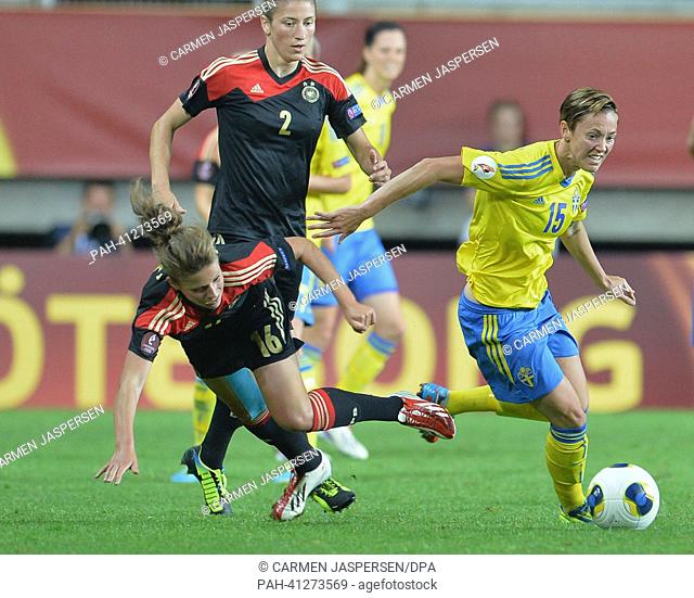 Melanie Leupolz (l) of Germany fights for the ball with Therese Sjögran of Sweden during the UEFA Women's EURO 2013 semi final soccer match between Germany and...
