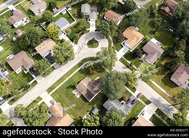 Aerial view of a tree-lined neighborhood in a cul-de-sac in a Chicago suburban city in summer