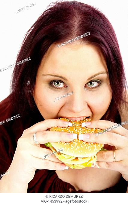 AUSTRIA , VIENNA , 11.01.2009, Young, fat woman eating a hamburger - Vienna, Vienna, AUSTRIA, 11/01/2009