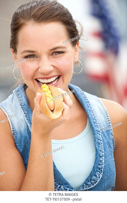 Woman eating hotdog