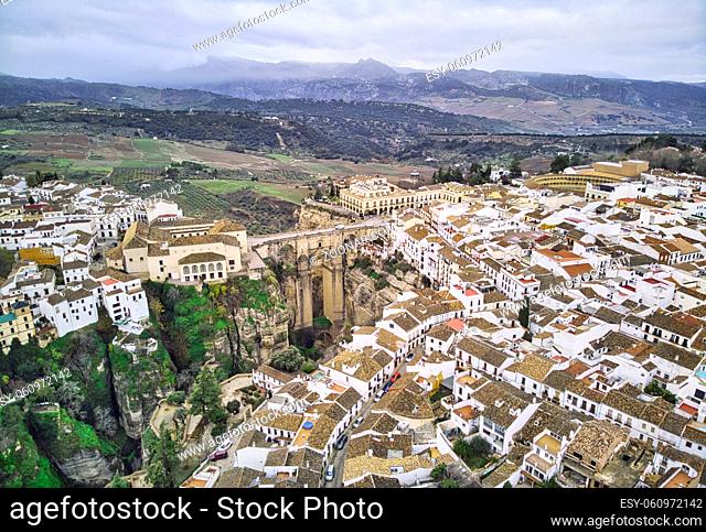 Aerial photography Ronda cityscape, residential houses buildings exterior rooftop, New bridge stunning canyons. Costa del Sol, Malaga, Spain