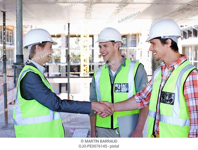 Construction worker shaking hands on construction site