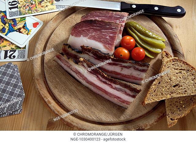 black forest ham with a gherking, cockteil tomatoes and playing cards