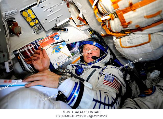 NASA astronaut Doug Wheelock, Expedition 24 flight engineer, attired in his Russian Sokol launch and entry suit, occupies his seat in the Soyuz TMA-19...