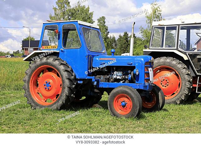 Colorful, classic Fordson Super Major tractor with cab on display on Kimito Traktorkavalkad, Tractor Cavalcade. Kimito, Finland - July 7, 2018