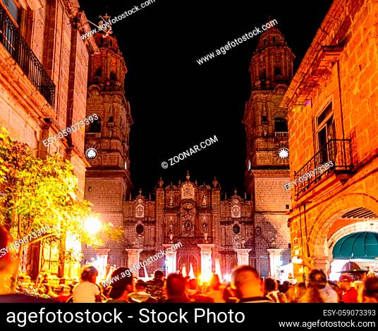 People gather infront of the Morelia Cathedral at night, enjoying the weekend, in the state of Michoacan, Mexico