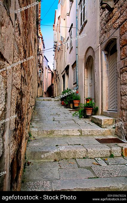 Narrow street in Korcula old town, Croatia. Korcula is a historic fortified town on the protected east coast of the island of Korcula