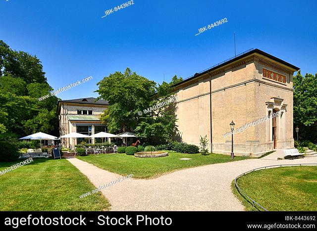 Baden-Baden, Germany, July 2021: Historic pump house called 'Trinkhalle' next to cafe with tables and umbrellas, Europe