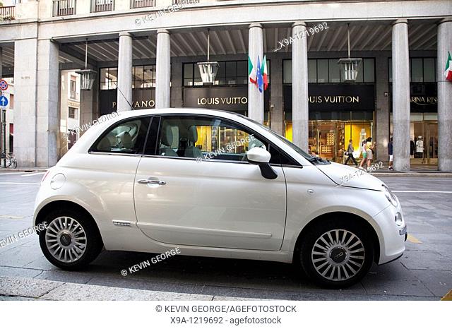 Fiat 500 car outside Louis Vuitton Shop in Via Roma Street in Turin, Italy