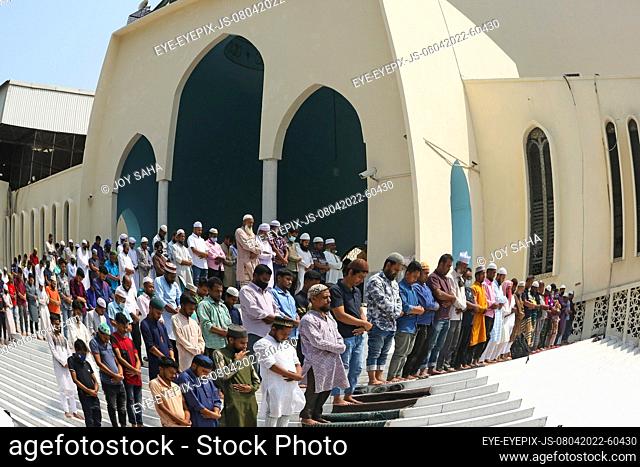 DHAKA, BANGLADESH - APRIL 8, 2022: Muslim devotees offer Jummah prayer during the holy month of Ramadan outside of the Baitul Mukarram National Mosque